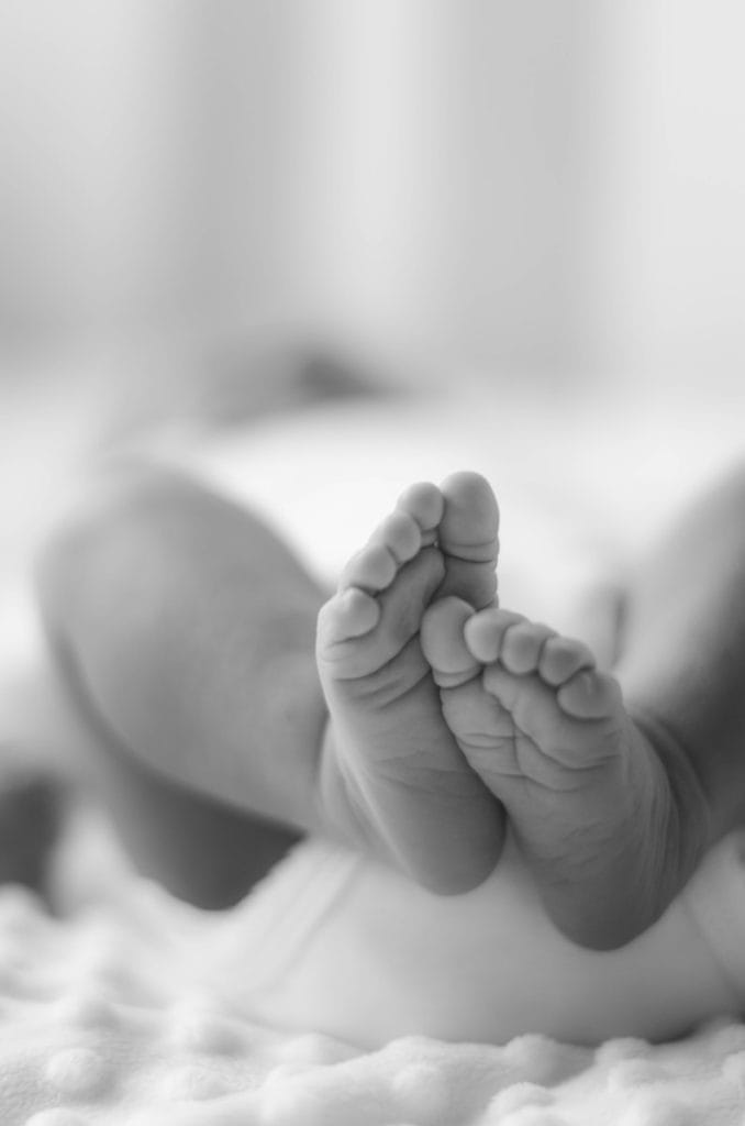 grayscale photo of babys feet