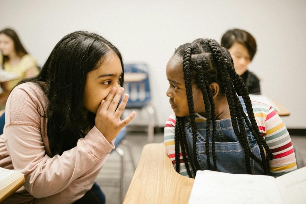 Modelo de petição de ação de reparação a título de danos morais e materiais por ser vítima de Bullying na escola 1 | Juristas Two Girls Gossiping With One Another
