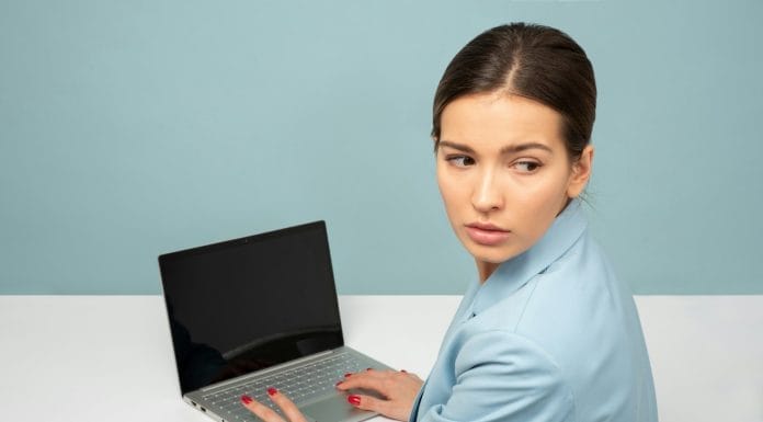 woman using laptop and looking side